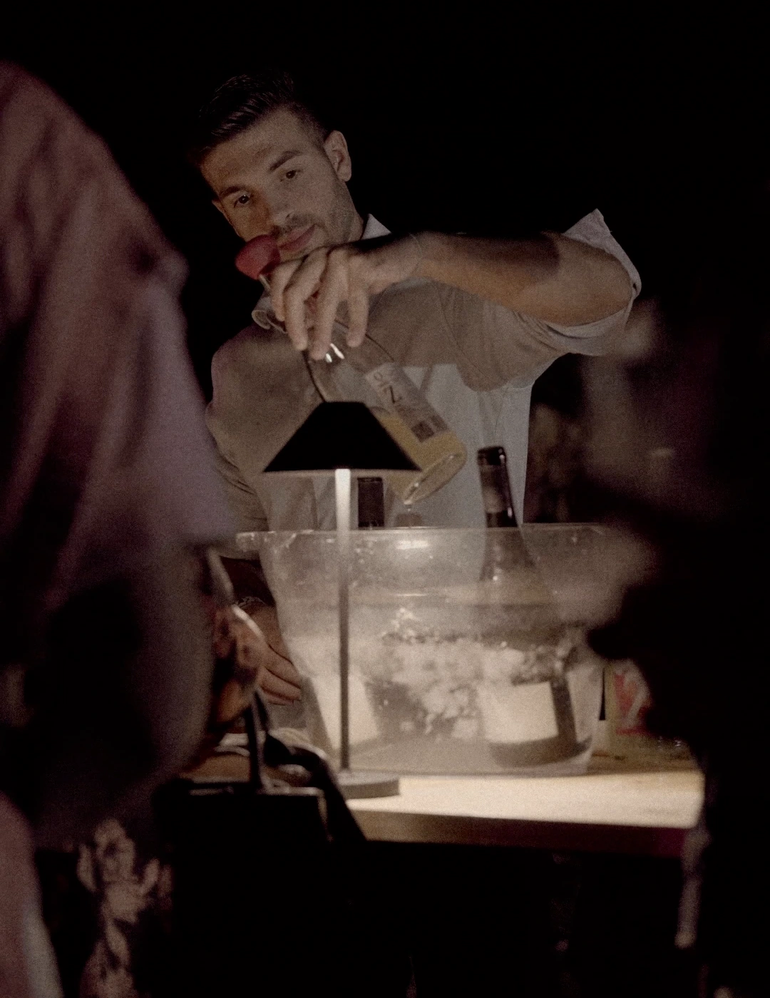 A host pouring wine during the Quartomoro collaboration in Sardinia