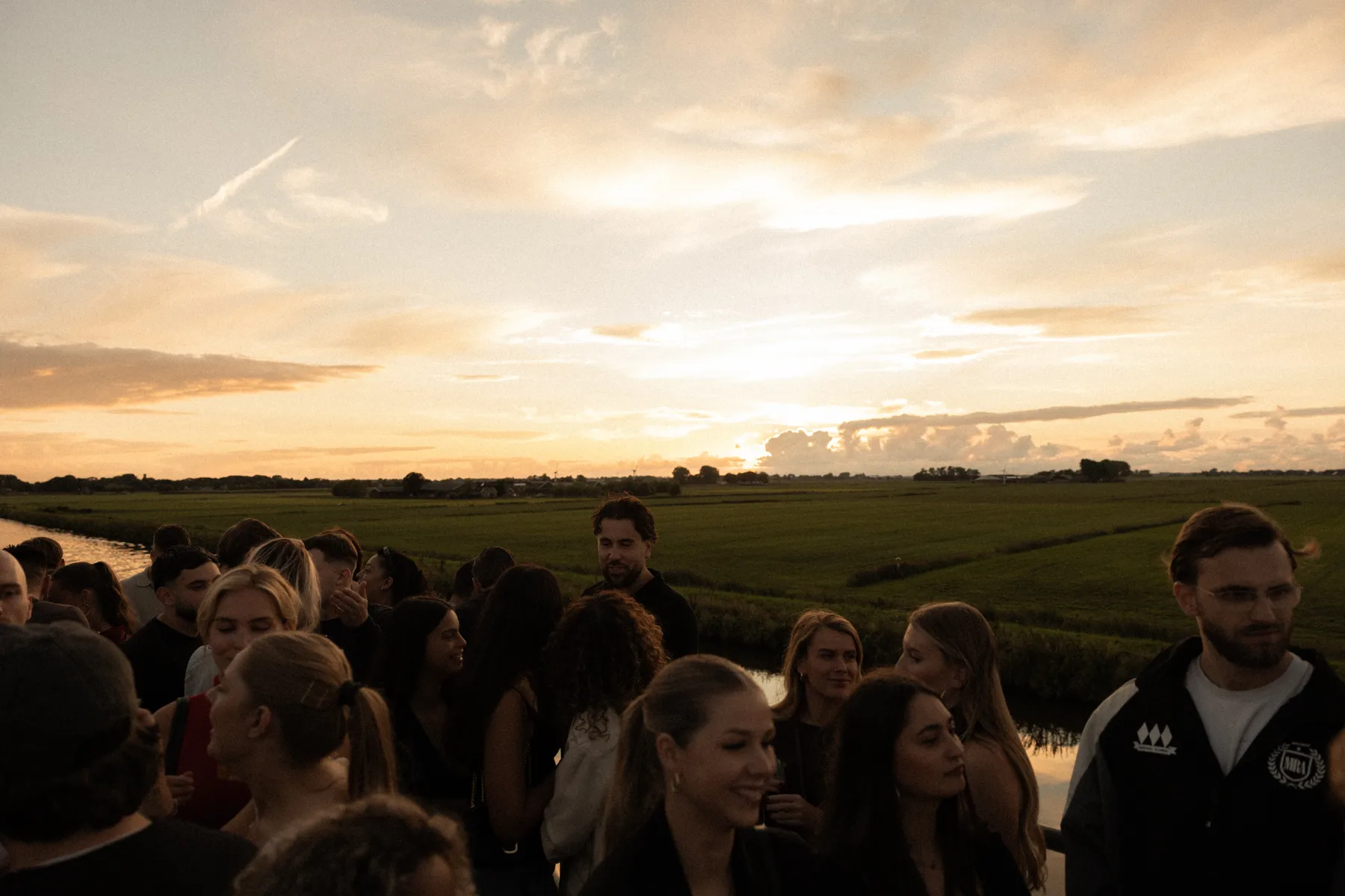 Sunset Cruise guests beside the Groningen landscape at sunset