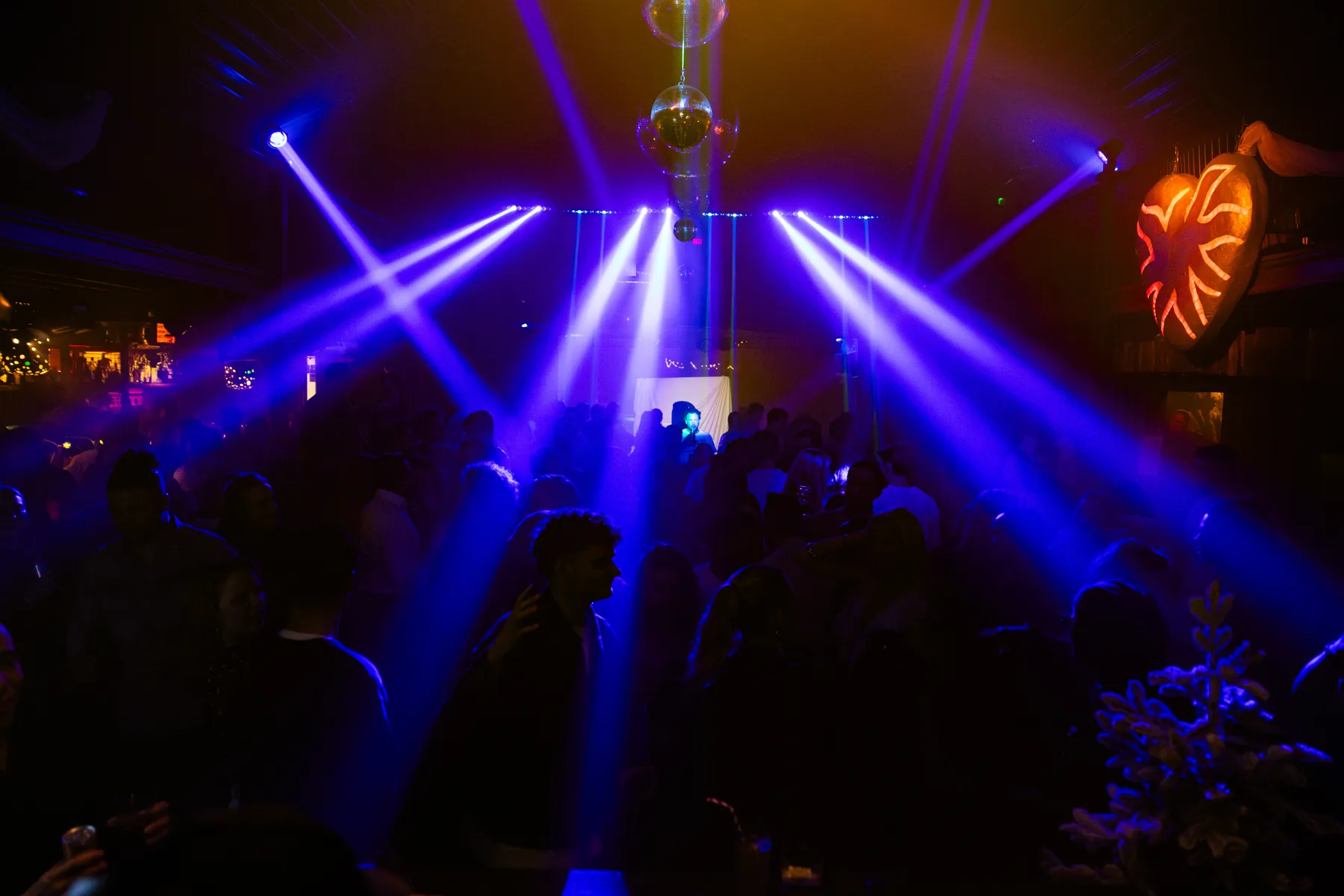 Blue-lit indoor crowd at Winter Paradise