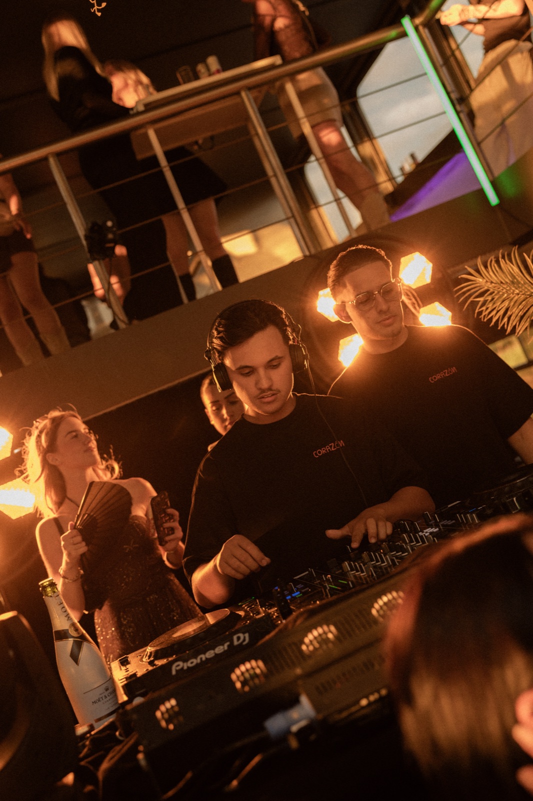 DJs performing in amber backlight during Sunset Cruise